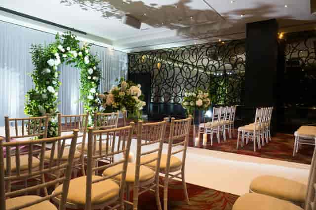 Elegant wedding venue at The Danziger, featuring a floral arch and romantic decor.