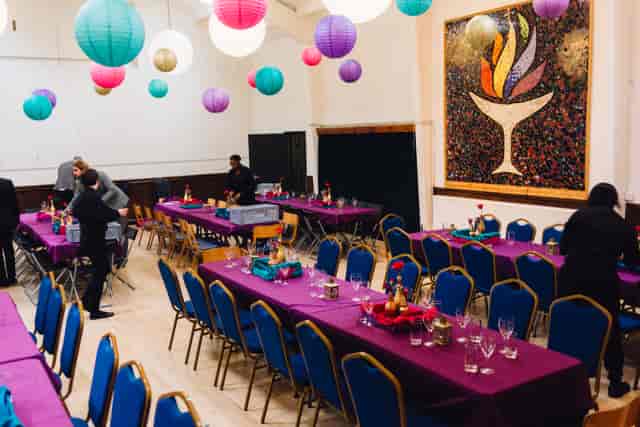 Vibrant event space in Unity Islington with purple tables and colorful lanterns for gatherings.