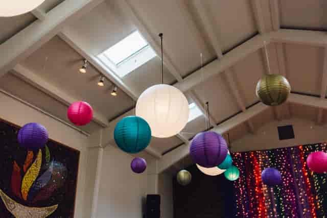 Vibrant event space with colorful lanterns in Unity Islington for celebrations and workshops.