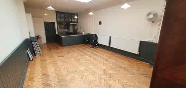 Small Hall in Unity Islington: versatile event space with polished wooden floor for workshops.