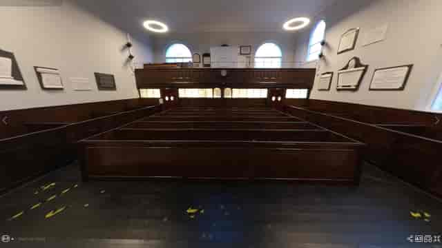 Main Hall in Newington Green Meeting House with wooden benches for workshops and conferences.