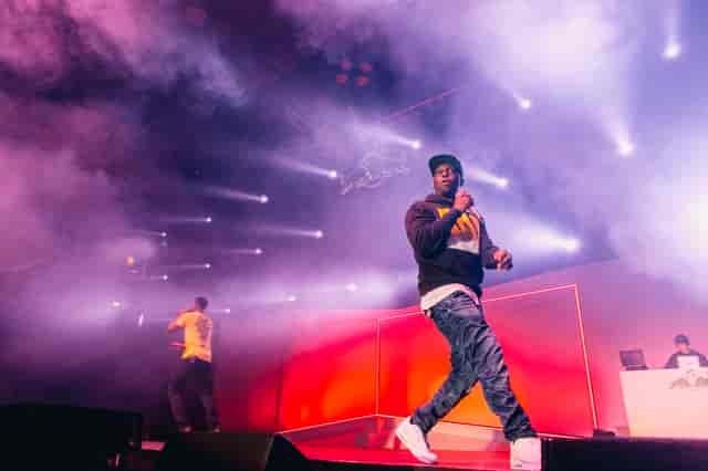 Dynamic live performance at Copper Box Arena with vibrant stage lighting and smoke effects.