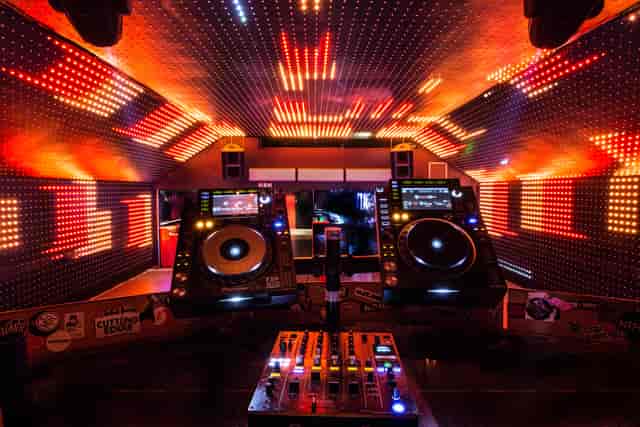Vibrant DJ booth with LED lights at Vauxhall Arches for music events.
