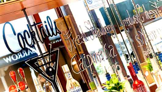 Stylish bar setup with mirrored backdrop for cocktails at Little Fable event venue.