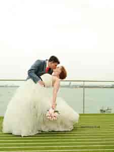 Couple sharing a romantic moment at No Man's Fort wedding venue by the water.