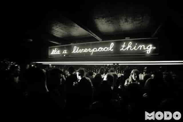 Vibrant networking event at Modo with neon "It's a Liverpool thing" sign.
