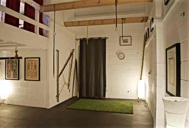 Versatile industrial event space with calming green accents for intimate gatherings.