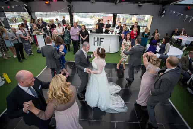 Vibrant wedding reception at Hotel Football with lively dance floor and modern decor.