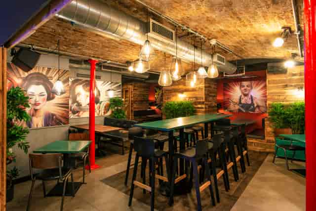 Event space in ICE BAR London with exposed brick and vibrant murals for creative meetings.