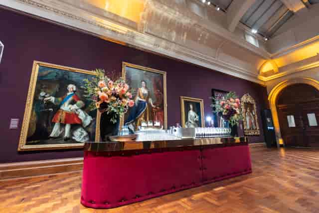 Elegant event setup at National Portrait Gallery with floral bar and classic artwork.