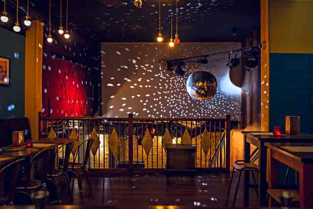 Vibrant Trapeze Bar Mezzanine with disco ball, perfect for events and gatherings.