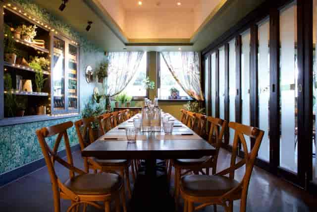 Small private dining room with long table, perfect for workshops and private dinners.