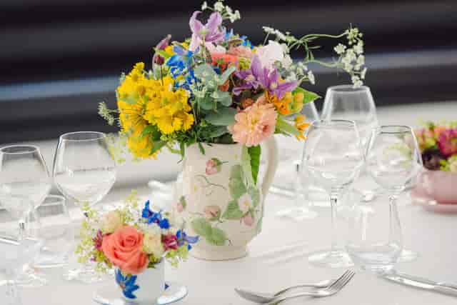Elegant table setting with floral centerpieces for upscale events in Altitude London.