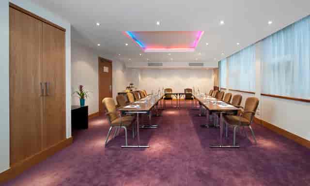 Modern meeting room at K West Hotel with long table, ideal for professional events.