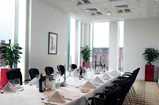 Boardroom at Hilton Deansgate, elegant dining setup for corporate events and gatherings.