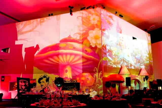 Vibrant event space with whimsical projections at Imperial War Museum North.