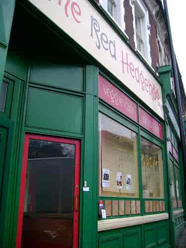 Quaint veggie café with vibrant green exterior, ideal for networking events and meetings.