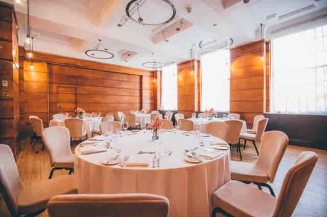 Elegant Bethnal Hall event space with round tables, ideal for meetings and celebrations.