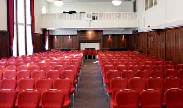 Council Chamber at Hallam Conference Centre with red chairs, ideal for conferences and presentations.
