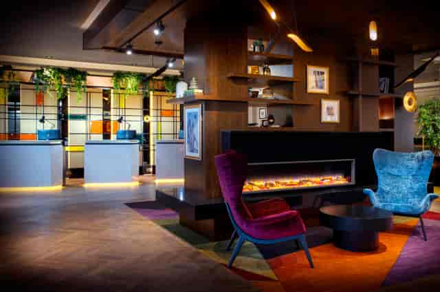 Executive Boardroom at Leonardo Royal Hotel, modern seating for networking events.