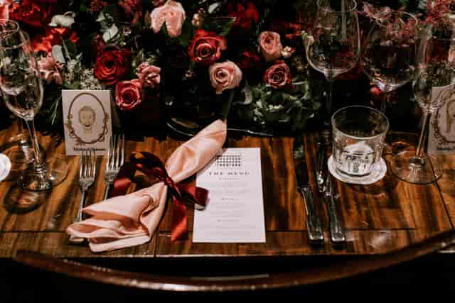 Elegant dining table with floral centerpiece for weddings and upscale events.