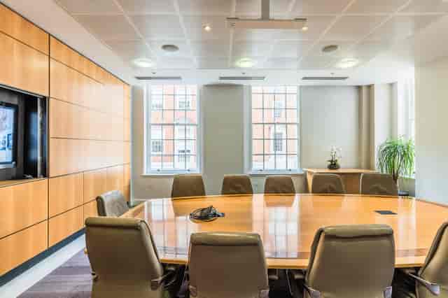 Modern conference room in BMA House with oval table, ideal for meetings and presentations.