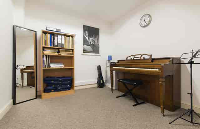 Cozy Small Music Room with piano for creative meetings and team-building activities.