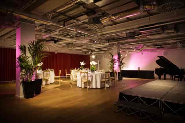 Elegant event space with round tables, ideal for corporate gatherings and celebrations.