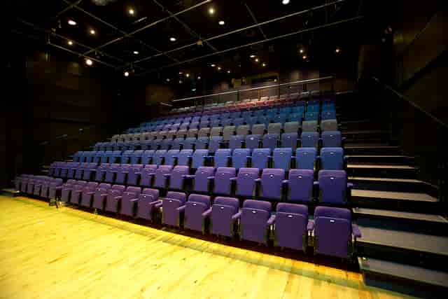 Modern auditorium with tiered purple seats for events at Birmingham Hippodrome.