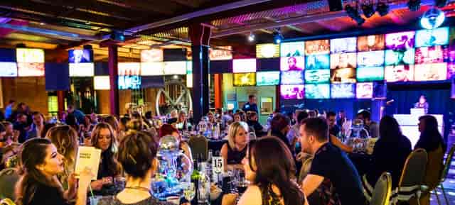 Revolution Manchester Gallery event space with elegantly dressed attendees networking.