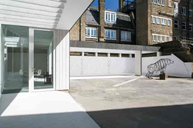 Modern outdoor event space at Bow Arts with unique sculpture and natural light.