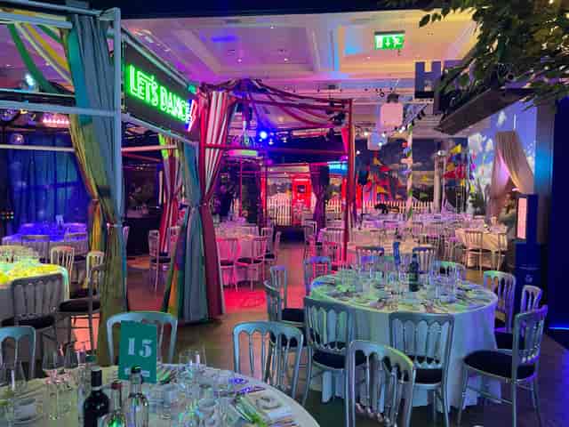 World Stage at Madame Tussauds, vibrant dinner setup with colorful lighting for events.