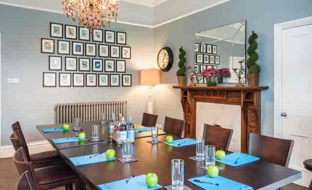Elegant boardroom with chandelier, perfect for meetings and workshops in Didsbury House Hotel.