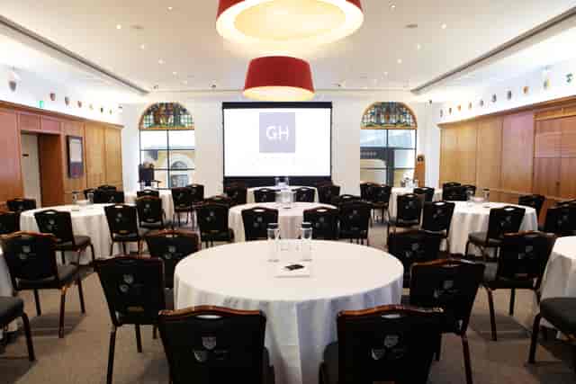 Court Room and Library in Glaziers Hall, set for conferences with round tables and screen.