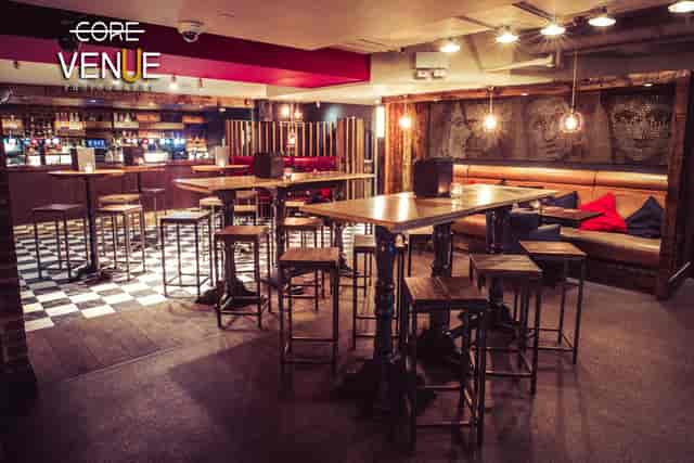 Stylish lounge with warm lighting, perfect for networking events and casual meetings.