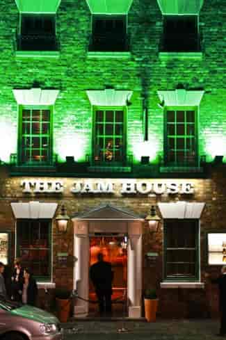 Vibrant The Jam House venue with green lighting, ideal for corporate events and gatherings.