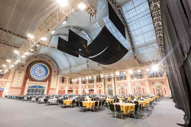 Great Hall at Alexandra Palace, elegant round tables for formal dinner event.