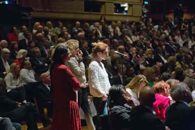 Barbican Hall event with engaged audience and microphone for interactive Q&A session.
