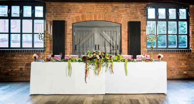 Waterside Room at IET Birmingham, elegant wedding venue with floral decor and natural light.