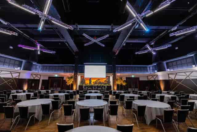 Live Room at Allianz Stadium, Twickenham: elegant conference venue with round tables.