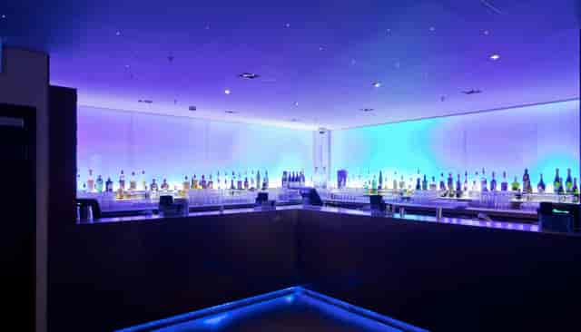 Sleek bar with purple lighting at Nuvo, ideal for networking events and cocktail receptions.