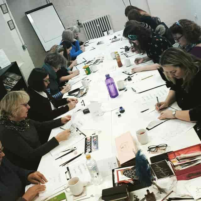 Collaborative workshop at Pen Museum, featuring diverse participants and hands-on activities.