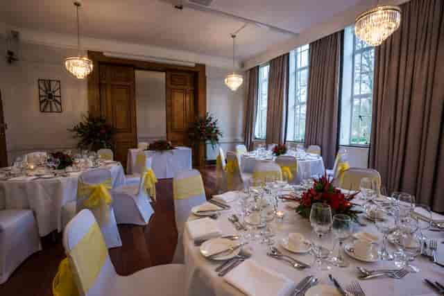 Elegant Tuke Common Room with round tables, ideal for weddings and corporate events.