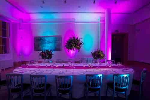 Elegant banquet table with floral centerpieces in Prince Philip House for upscale events.