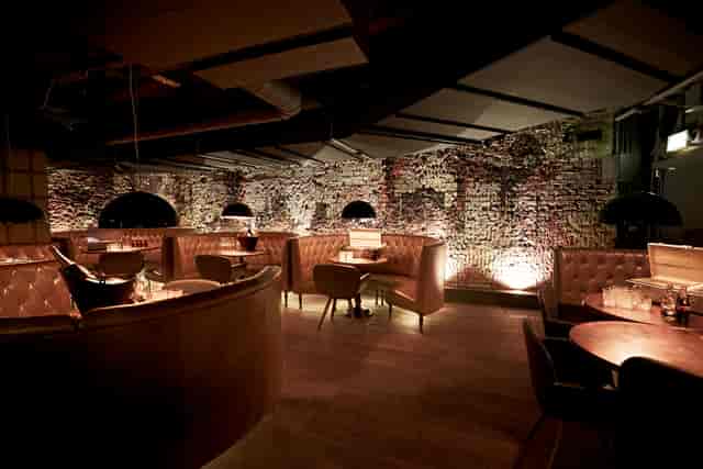 Stylish intimate dining space in Club Forge for upscale events and corporate gatherings.