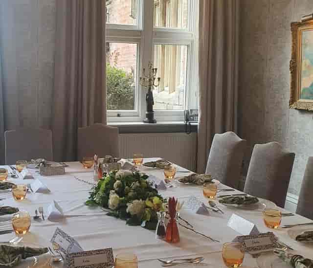 Churchill Suite meeting room with floral centerpieces for elegant events and gatherings.