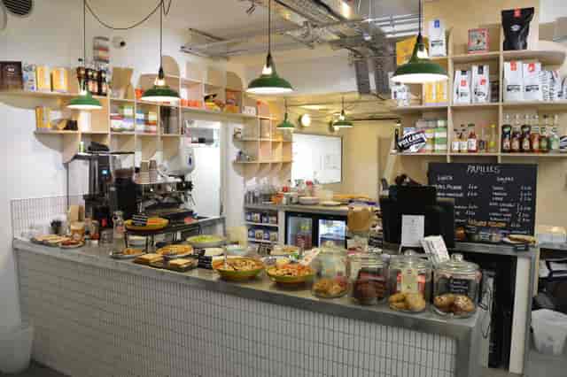 Modern café venue with inviting counter, ideal for networking and informal meetings.