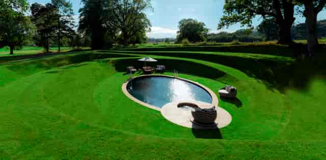 Exclusive Use Manor House with oval pool, ideal for upscale events and retreats.