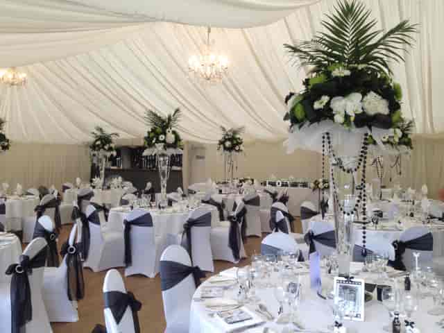 Elegant event space at Quendon Hall with floral centerpieces for weddings and gatherings.