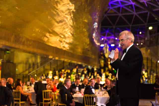 Elegant gala at The Dry Berth, Cutty Sark with sophisticated attendees and modern architecture.